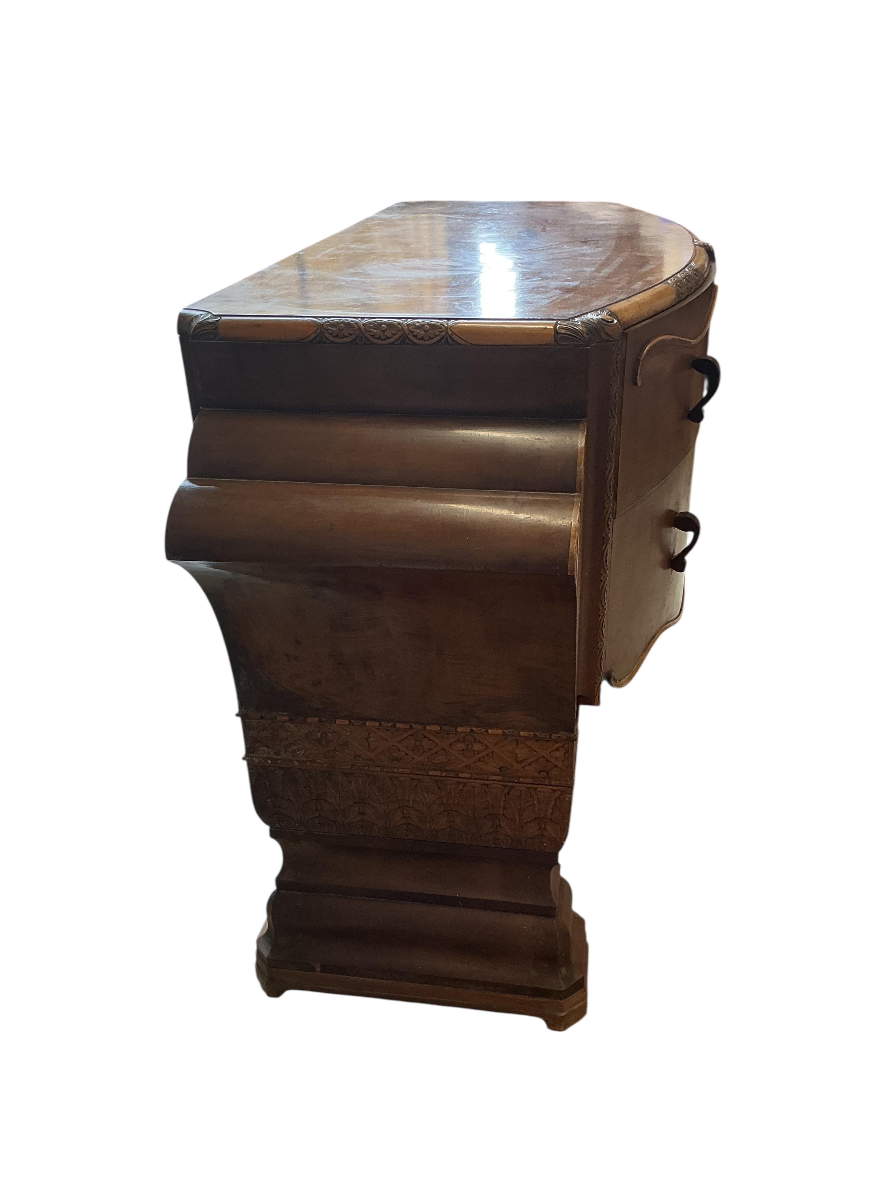 An Art deco walnut dining suite, comprising: dining table, width 190cm, depth 110cm, height 80cm together with eight chairs (two being carvers) and a bow front sideboard